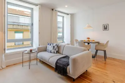 a living room with a couch and a table at Bright & Characterful Home by HostWise in Porto