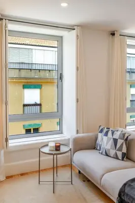 a living room with a couch and a window at Bright & Characterful Home by HostWise in Porto