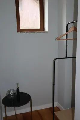 a bedroom with a bed and a chair and a lamp at Porto Central Apartment in Porto