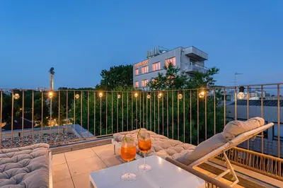 a patio with a table and two drinks on a balcony at GuestReady - Top floor lodge with a stunning view in Porto