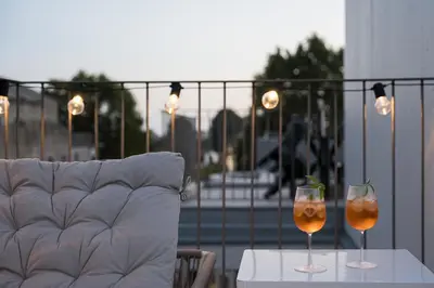 two wine glasses sitting on a table on a balcony at GuestReady - Top floor lodge with a stunning view in Porto