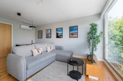 a living room with a couch and a window at GuestReady - Top floor lodge with a stunning view in Porto