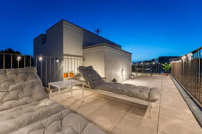 a large couch sitting on top of a patio at GuestReady - Top floor lodge with a stunning view in Porto