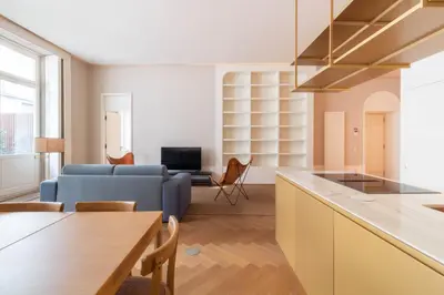 a bedroom with a large bed with a yellow blanket at Entreparedes House in Porto
