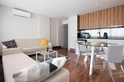 a living room with a couch and a table with chairs at GuestReady - Bahl Apartments in Porto