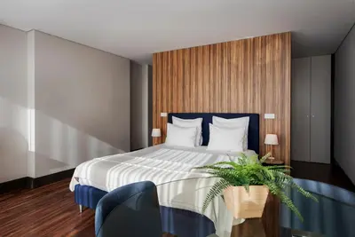 a hotel room with a large bed and a table at GuestReady - Bahl Apartments in Porto