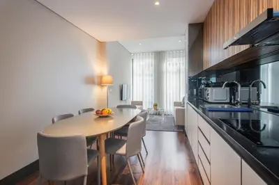 a kitchen with a table and chairs in a room at GuestReady - Bahl Apartments in Porto