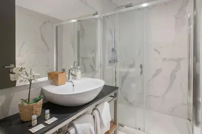 a bathroom with a white sink and a shower at GuestReady - Bahl Apartments in Porto