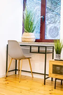 a desk with a chair and a table with plants at Magnificent Cais de Gaia Duplex in Vila Nova de Gaia