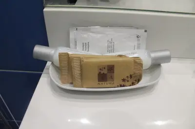 a white toilet with a towel on a plate at Seculo Soft in Porto