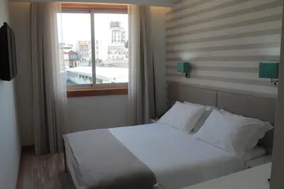 a bedroom with a white bed and a window at Seculo Soft in Porto