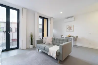a living room with a couch and a table at Bonfim Charming Flats by HostWise in Porto