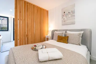 a bedroom with a large bed with a tray on it at Bonfim Charming Flats by HostWise in Porto