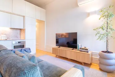 a living room with a couch and a table at Deluxe Design 1BR w Terrace by LovelyStay in Porto
