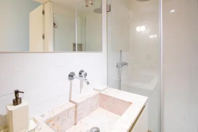 a bathroom with a marble sink and a shower at Deluxe Design 1BR w Terrace by LovelyStay in Porto