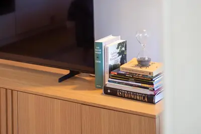 a pile of books sitting on top of a tv at Deluxe Design 1BR w Terrace by LovelyStay in Porto