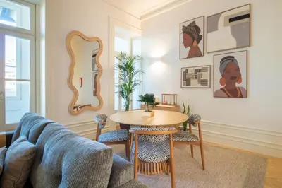 a living room with a table and a couch at Deluxe Design 1BR w Terrace by LovelyStay in Porto