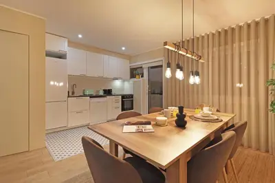 a kitchen and dining room with a wooden table and chairs at ON Apartments - Family - Free Parking & Pet Friendly in Porto