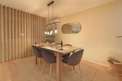 a dining room with a wooden table and chairs at ON Apartments - Family - Free Parking & Pet Friendly in Porto