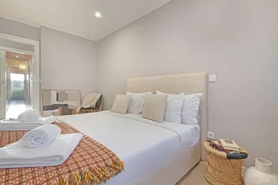 a bedroom with a large white bed with white pillows at ON Apartments - Family - Free Parking & Pet Friendly in Porto