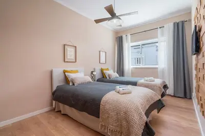 a bedroom with two beds and a window at The Heritage Flat in Porto