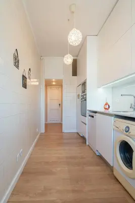 a kitchen with a washer and dryer at The Heritage Flat in Porto