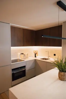 a kitchen with wooden cabinets and a sink at Casa de Santa Catarina by OportoSoul in Porto