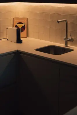 a kitchen counter with a sink and a napkin dispenser at Casa de Santa Catarina by OportoSoul in Porto