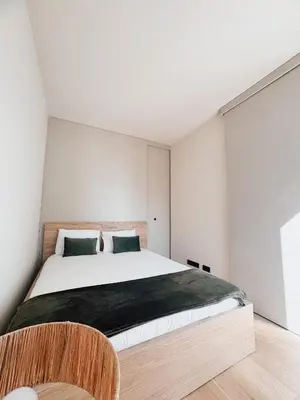 a bedroom with a large bed with green pillows at Casa de Santa Catarina by OportoSoul in Porto