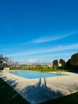 a shadow of a person standing next to a swimming pool at Skyline Heaven - Fantastic View - Pool - Garage in Vila Nova de Gaia