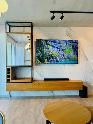 a living room with a large tv on a wall at Skyline Heaven - Fantastic View - Pool - Garage in Vila Nova de Gaia
