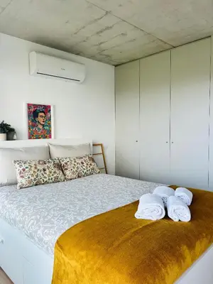 a bedroom with a bed with towels on it at Skyline Heaven - Fantastic View - Pool - Garage in Vila Nova de Gaia