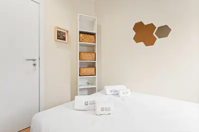 a white room with a bed with boxes on it at GuestReady- Charming Porto Retreat with Terrace in Porto