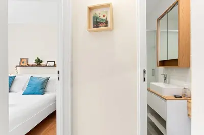 a white bathroom with a bed and a sink at GuestReady- Charming Porto Retreat with Terrace in Porto