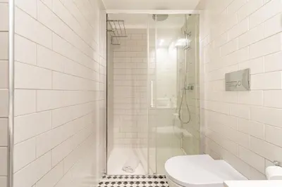 a white bathroom with a shower and a toilet at Oporto Center Studio in Porto