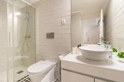 a bathroom with a sink and a toilet and a shower at Oporto Center Studio in Porto
