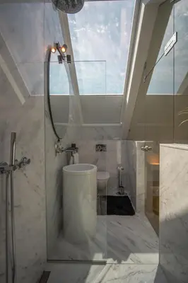 a bathroom with a shower and a toilet in a room at The Dome in Porto