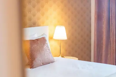 a bedroom with a bed with a pillow and a lamp at Golden Comfort CasaBela 7 Star by LovelyStay in Porto