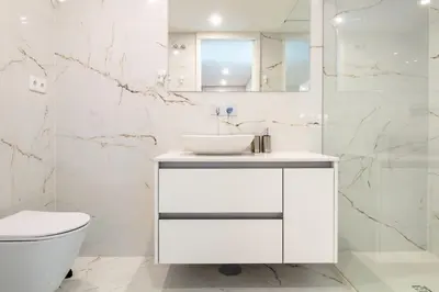 a white bathroom with a sink and a toilet at Golden Comfort CasaBela 7 Star by LovelyStay in Porto