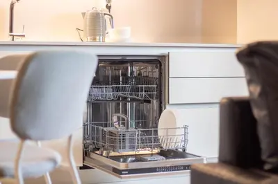 a dishwasher with dishes in it in a kitchen at Golden Comfort CasaBela 7 Star by LovelyStay in Porto