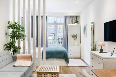 a living room with a couch and a bed at Serene Porto Studio @ Marquesa Palace in Porto