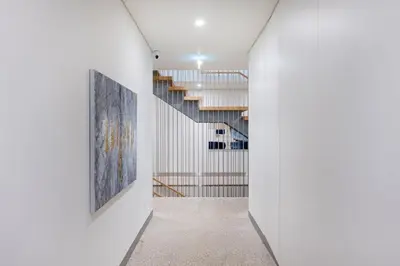 a hallway with white walls and stairs with paintings on the walls at Serene Porto Studio @ Marquesa Palace in Porto