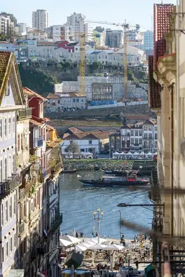 a bedroom with a large bed with towels on it at Ribeira Apartments São João in Porto