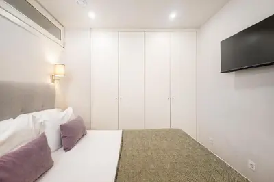 a living room with a couch and a table at Ribeira Apartments São João in Porto