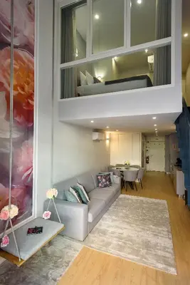 a white bedroom with a bed with white pillows at Ribeira Apartments São João in Porto