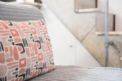 a pillow sitting on a bed in a room at GuestReady - Charming Porto retreat in Porto