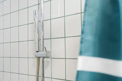 a shower head in a bathroom with white tiles at GuestReady - Charming Porto retreat in Porto
