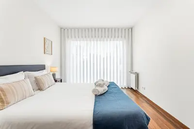 a bedroom with a bed with a teddy bear on it at GuestReady - cosy retreat in Vila Nova de Gaia in Vila Nova de Gaia