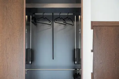 a glass door of a refrigerator with four hangers at GuestReady - cosy retreat in Vila Nova de Gaia in Vila Nova de Gaia