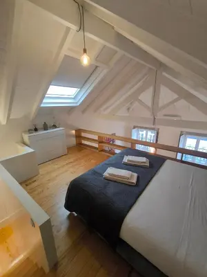 a bedroom with a bed with two towels on it at ALMADA LOFT LIVING by We Do Living in Porto